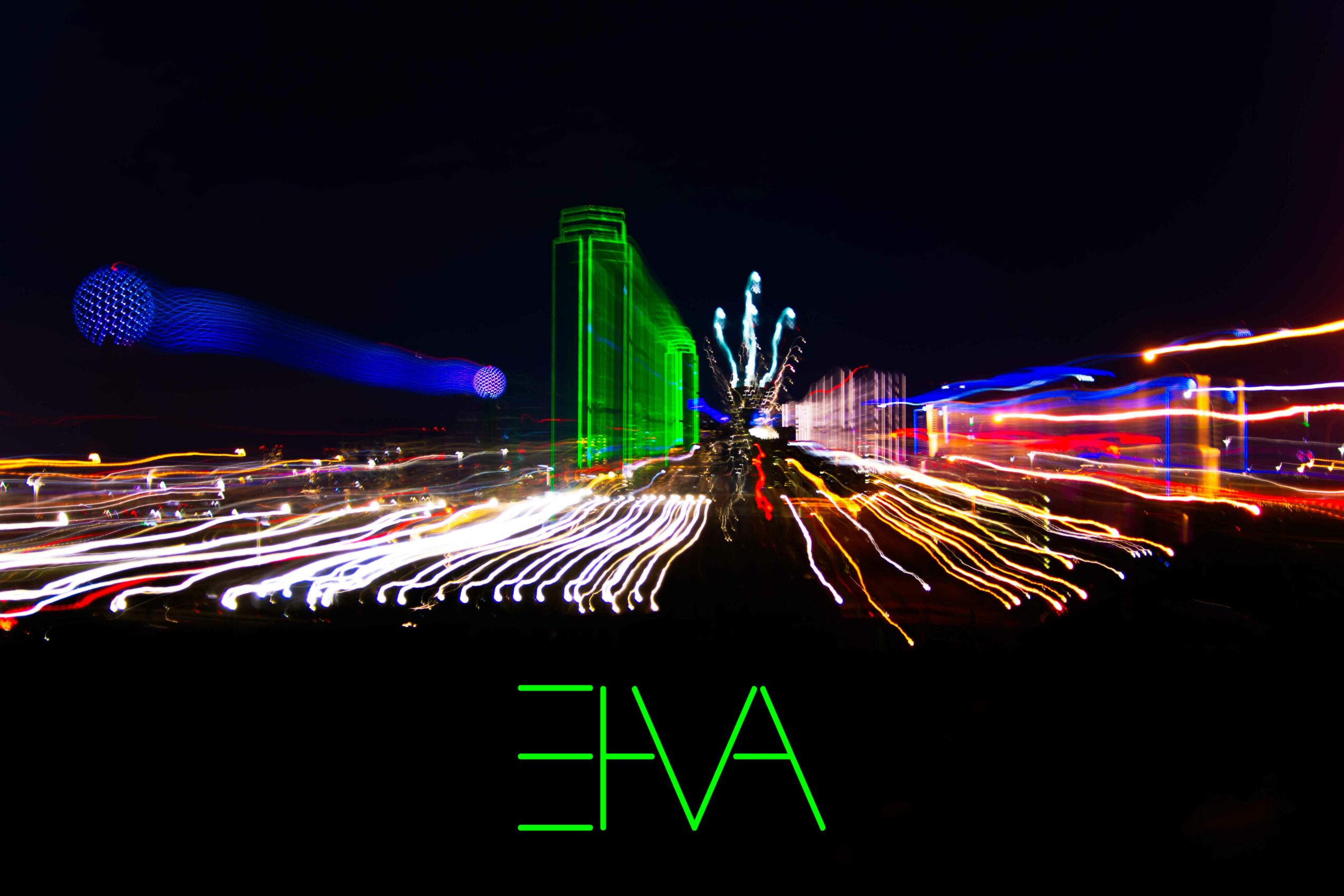 Night cityscape with colorful light trails, a green building, and fireworks, with the word 'LOVE' in green at the bottom.