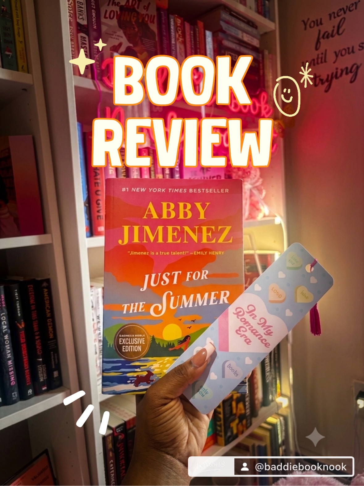 Person holding a book titled 'Just for the Summer' by Abby Jimenez in a bookstore, with bookshelves in the background.