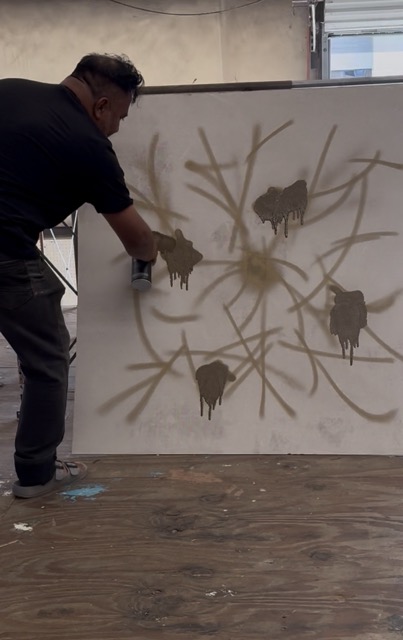 Person creating shadow puppets of pigs on a white wall with sunlight, using hands and objects.