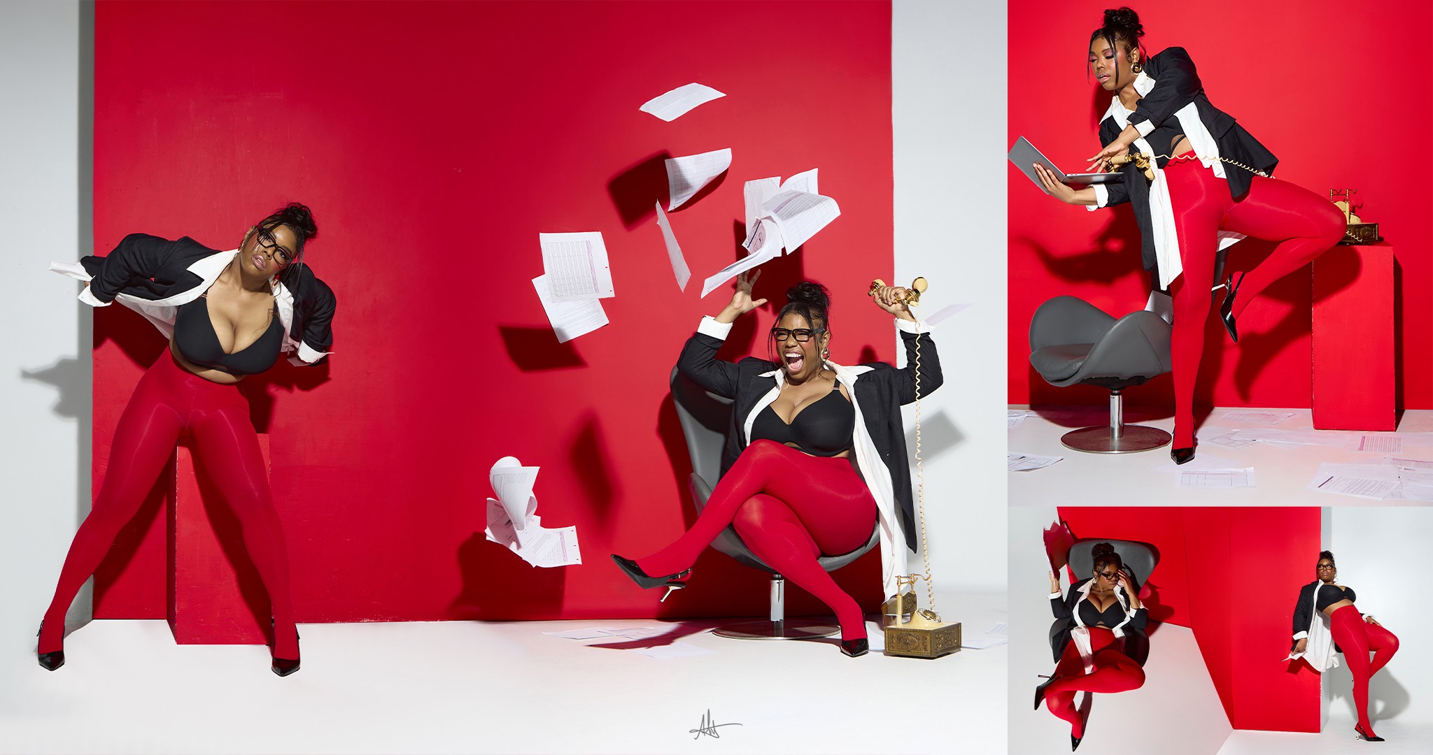 Three people in black and red outfits with papers and a trophy against a red background.