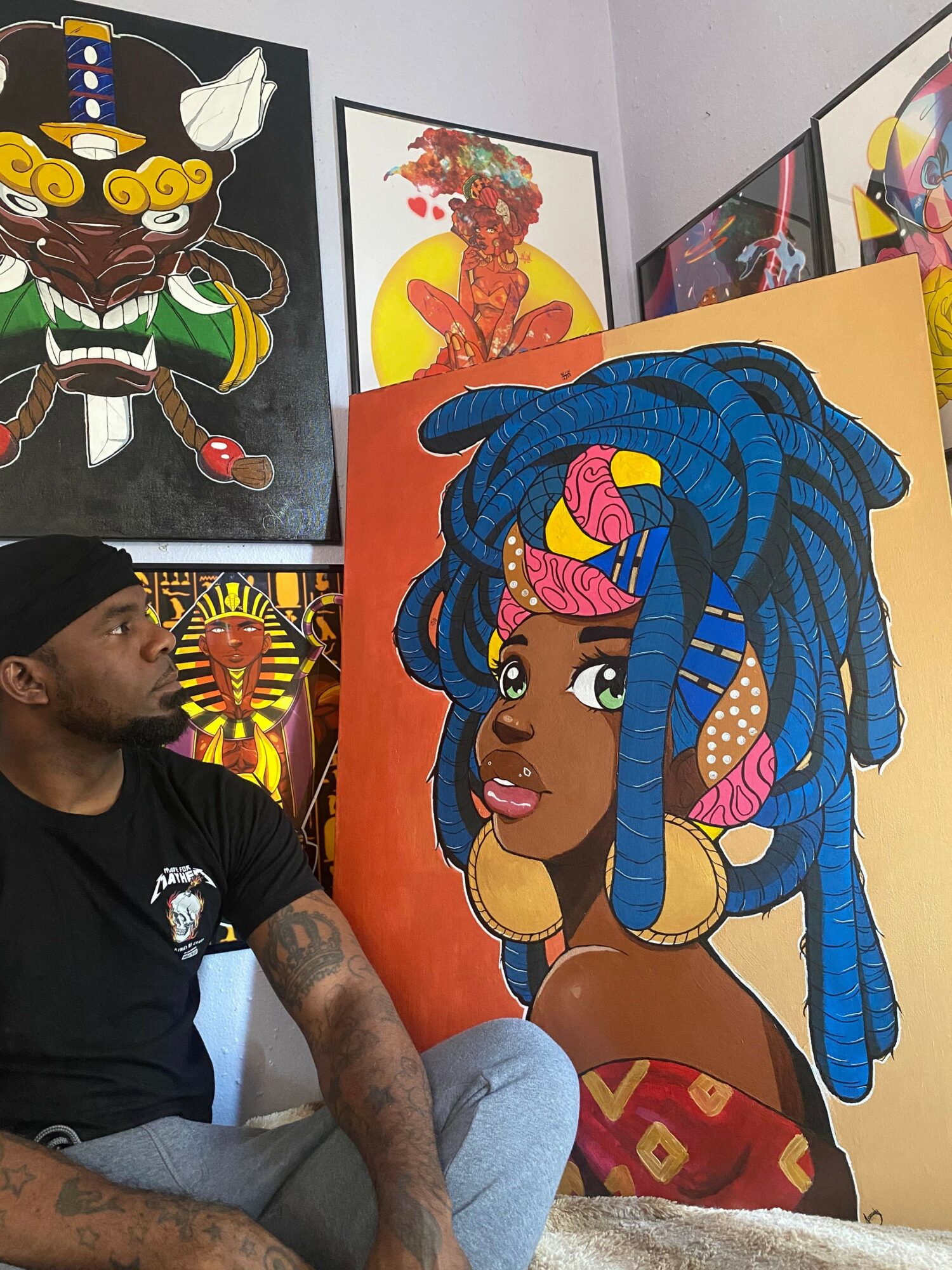 Colorful painting of a woman with blue dreadlocks, large earrings, and a pink top, displayed on an orange background.