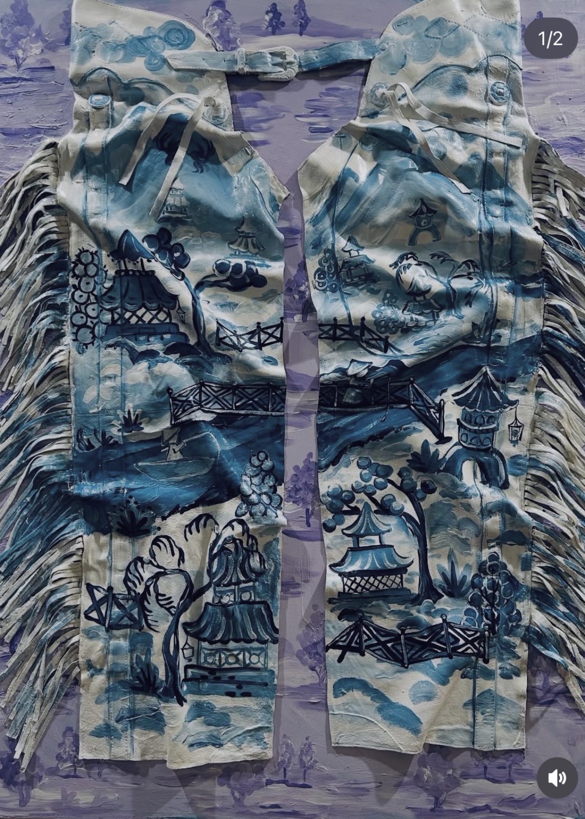 Two fabric pieces with blue and white patterns, fringes on the sides, laid on a purple surface.