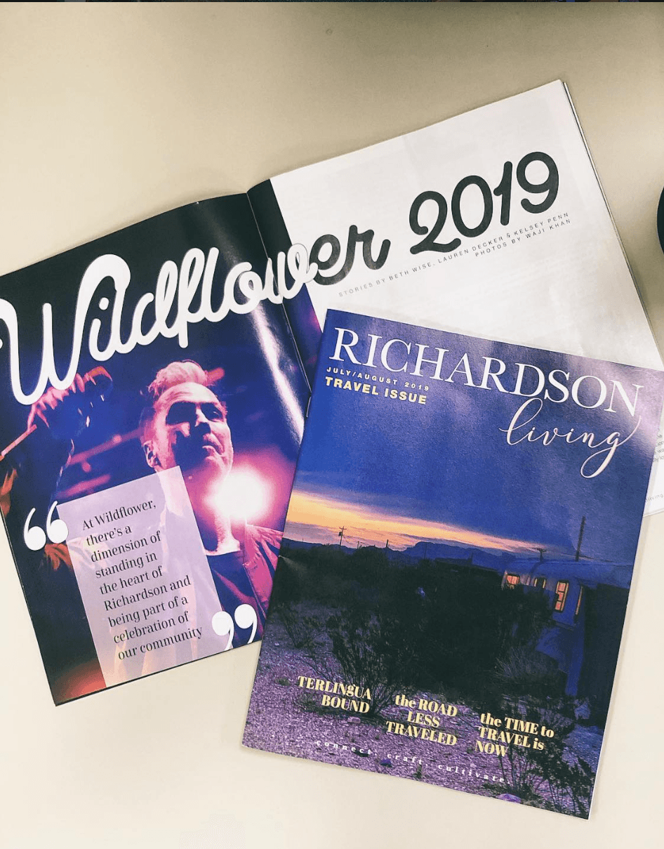 Open magazine with a person on a stage and a travel magazine with a landscape scene, both on a light-colored surface.
