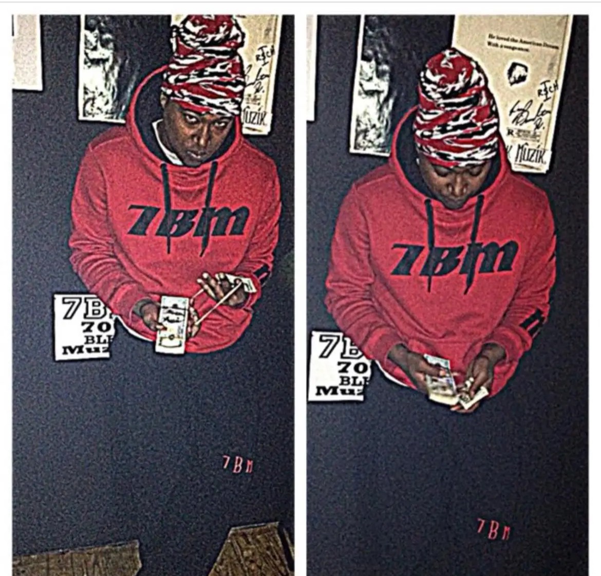 Person wearing a red hoodie and striped hat, looking at a phone and holding cash, standing against a dark wall.
